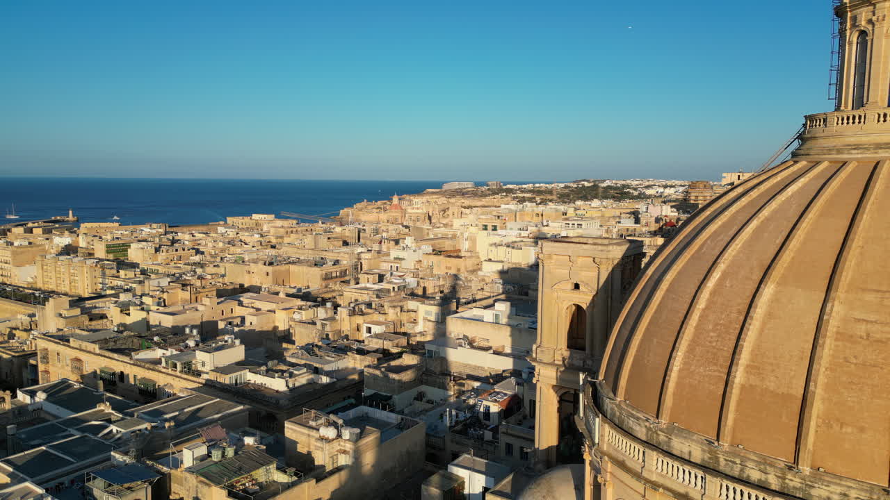 Aerial drone view of the walled city of Valletta, Malta, surrounded by the Mediterranean sea in daylight