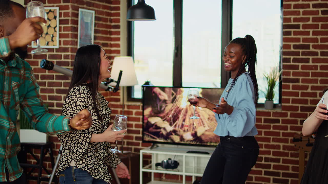 Happy group of friends enjoying time spent together, busting into energetic dance moves