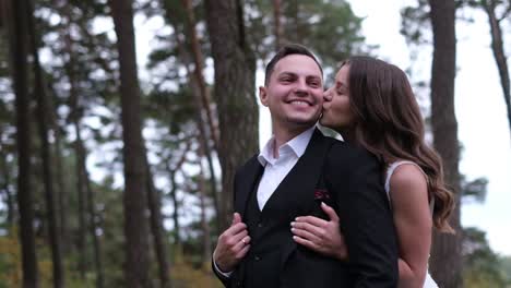 young couple on their wedding day walking in a pine park young couple on their wedding day walking in a pine park bride and groom outdoors in the woods