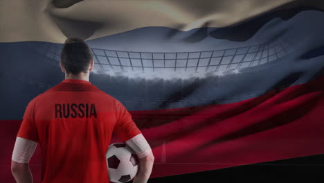 russian soccer player with russia flag against soccer stadium