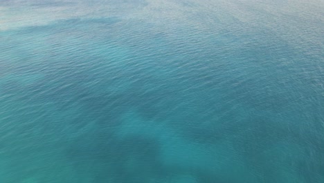 Drone-rises-above-the-sea-in-Zakynthos-island,-Greece