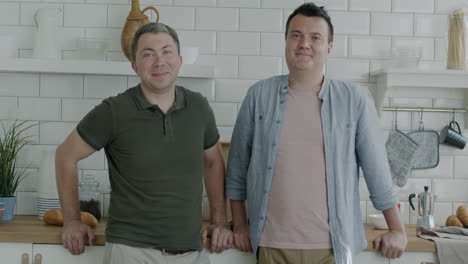 two men smiling in a kitchen