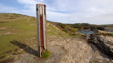 Wide shot of HMS Warspite monument with Bessy&#039;s Cove,The Enys in background
