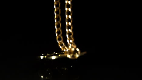 gold dollar chain falling on black background