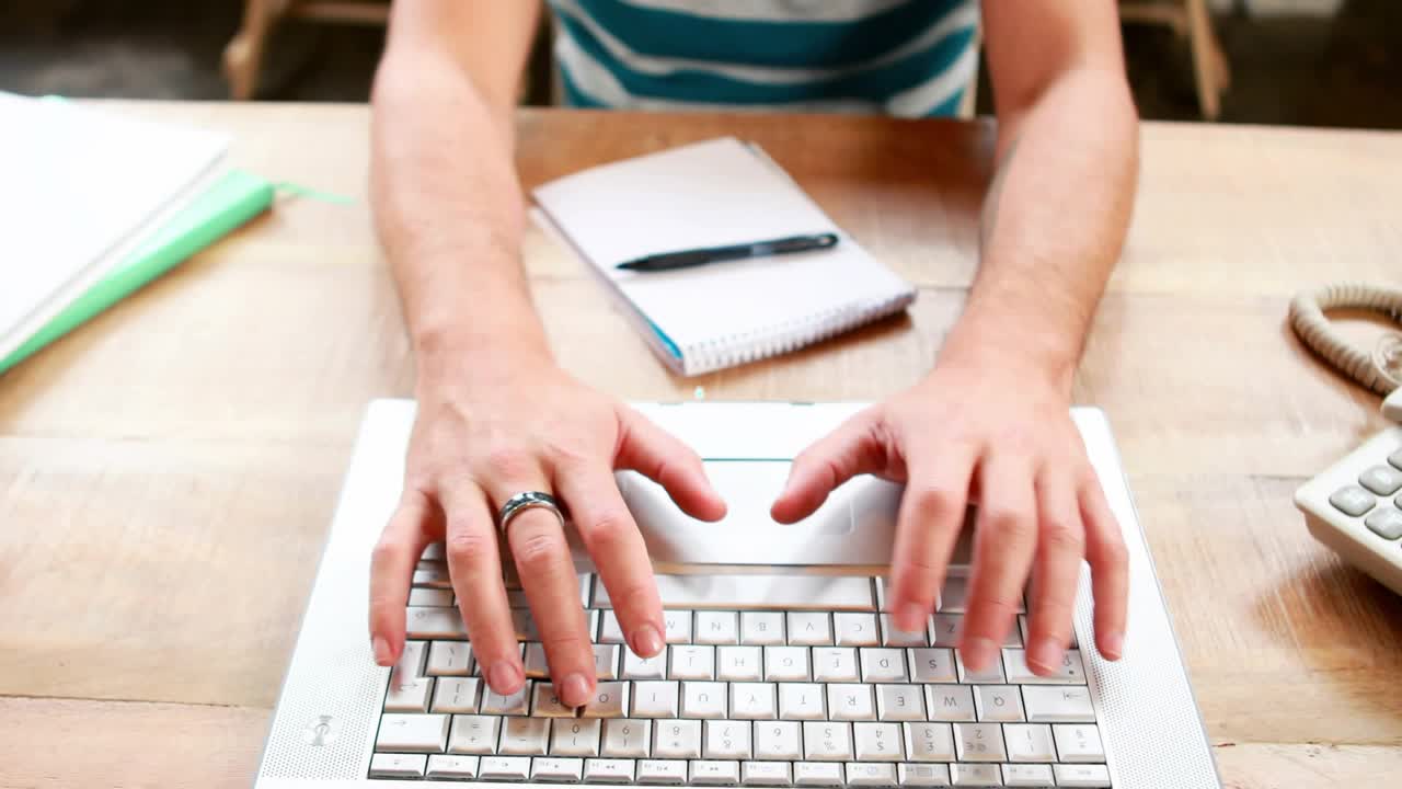Man typing on laptop at desk, causing animated green avatar links growing tech network for work