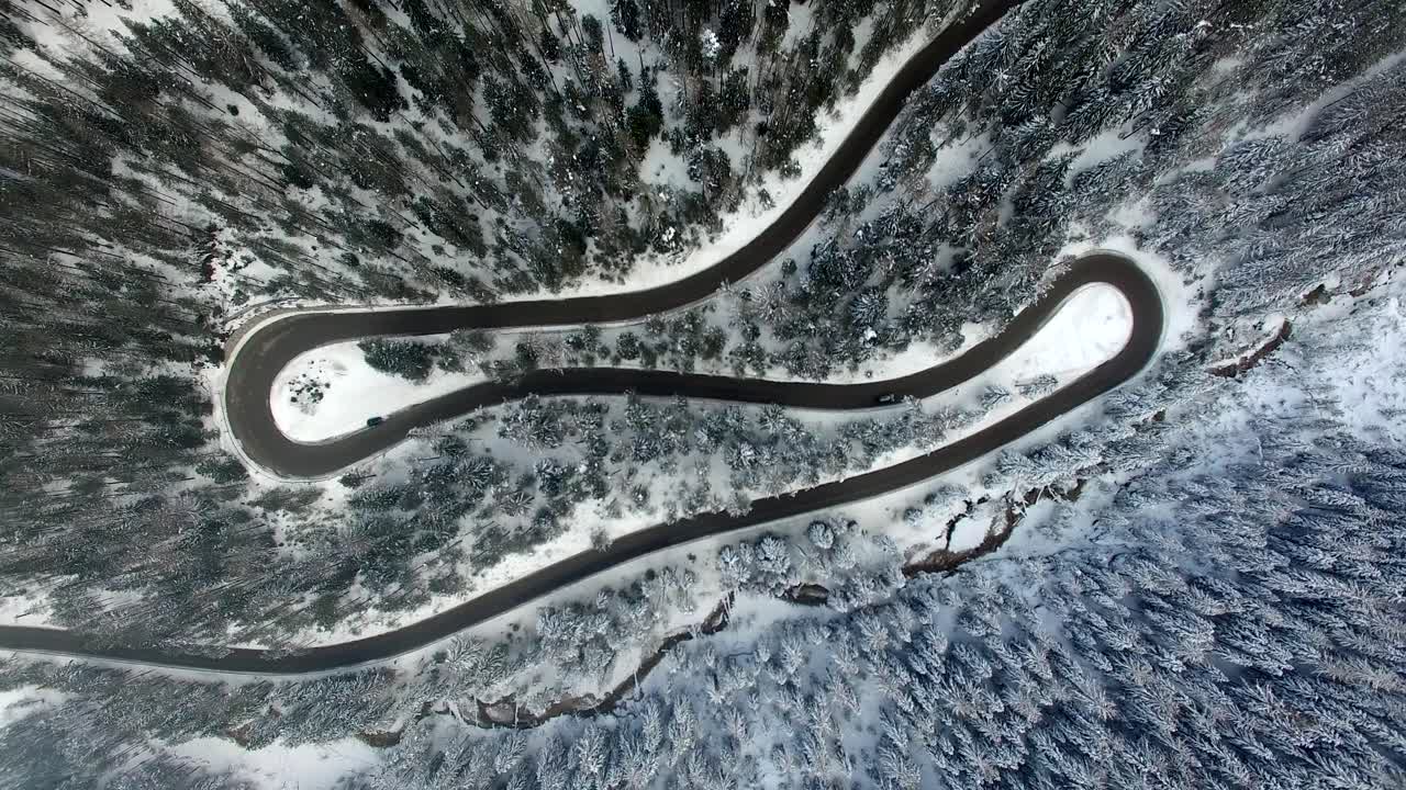 AERIAL: Road in Forest with snow in Dolomites