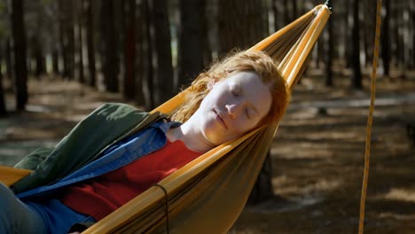 woman sleeping on a hammock in the forest 4k