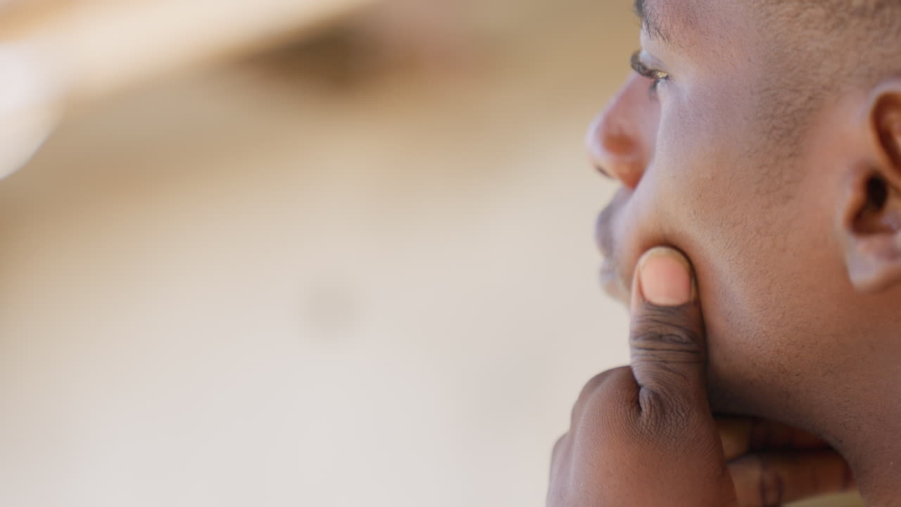 Athlete breathing into hands between sets, closeup of mouth and fingers, gentle exhale, towel wiping sweat, checking cheek and jaw, slow recovery pause after intense drill, sidelines training yard