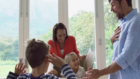 Family-opening-cardboard-box-at-new-home-4k