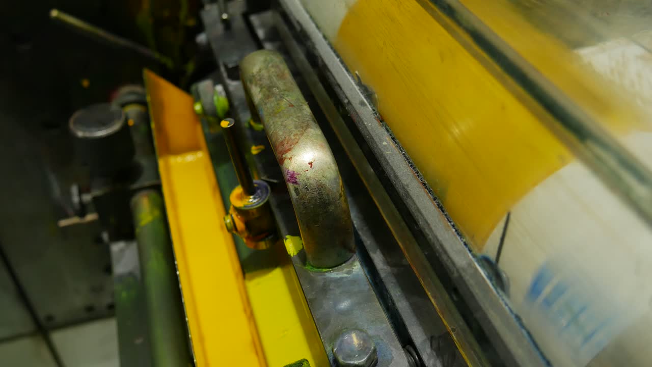 yellow paint in the process of printing by colors, the roll takes the paint it needs to print the labels in the factory's chain production