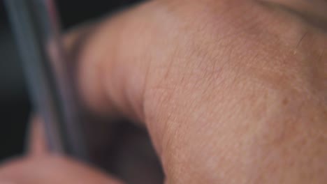 man taps with new ball pen on blurry background macro