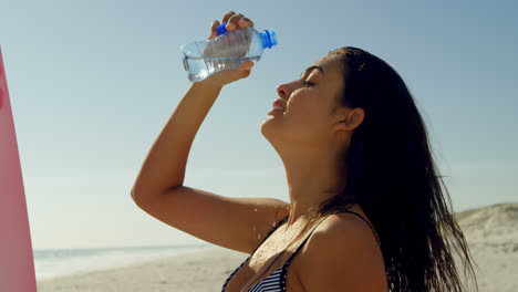 Female-surfer-pouring-water-over-her-face-4k