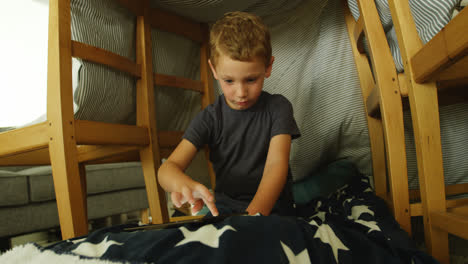 boy using digital tablet in living room 4k