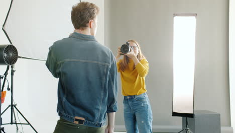 photographer taking a portrait in a studio