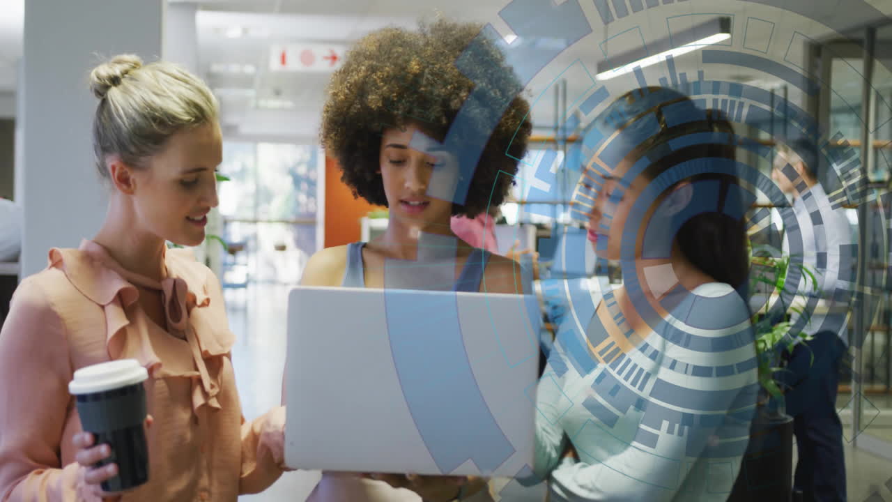 Three women collaborating over laptop with digital data processing animation overlay