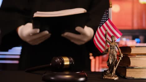 a detailed courtroom scene depicting a gavel, a statue of lady justice, and an american flag symbolizing law and order