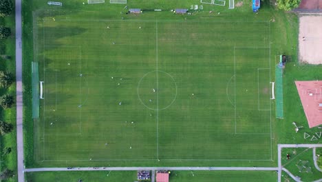 aerial view directly on the field under the camera, where the football players are moving and playing