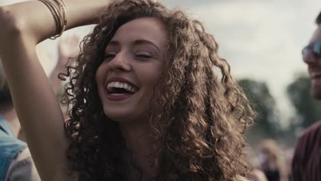 Close-up-of-caucasian-woman-with-curly-hair-dancing-on-music-festival.