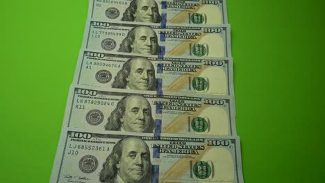 100 dollars notes on the green screen.
