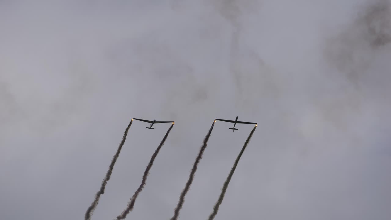 Glider of the Flying Bulls from Team Blanix flies impressive performances while dragging clouds of smoke with them. They turn away. Airpower 2024