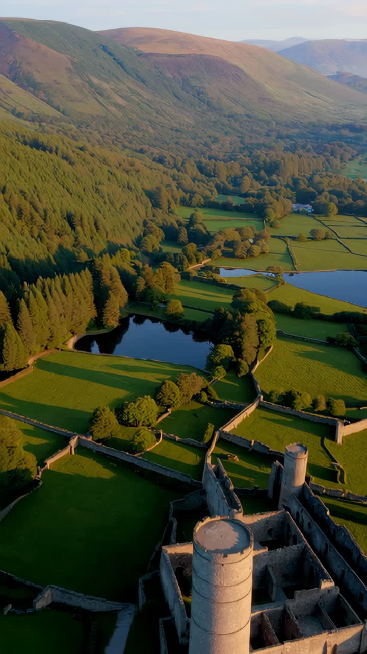 Aerial View of Ancient Castle Ruins in Lush Green Landscape with Lakes