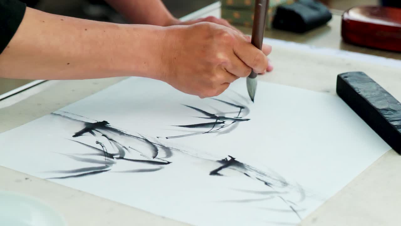 Slow Motion Footage of a Japanese Man Painting a Nihonga, a Traditional Japanese Painting, with Brushes and Black Ink