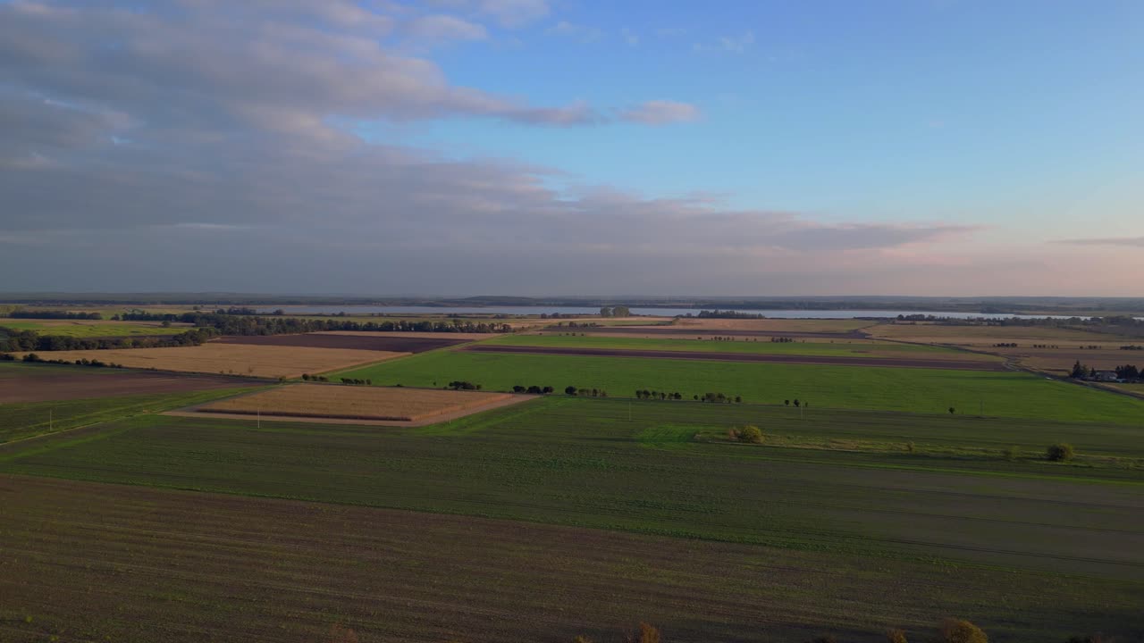 Aerial View of Agricultural Fields and Lake at Sunset