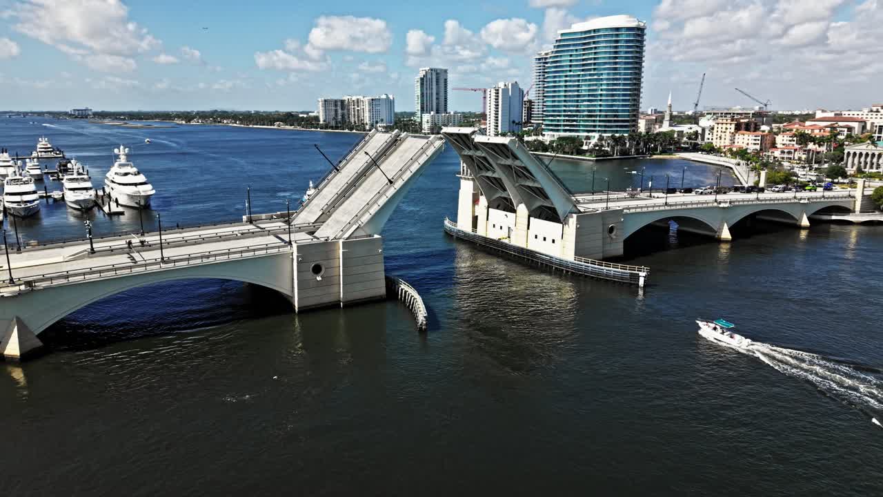 Aerial: Royal Park Bridge opening with boats during the day in West Palm Beach, Florida, USA, orbit drone shot