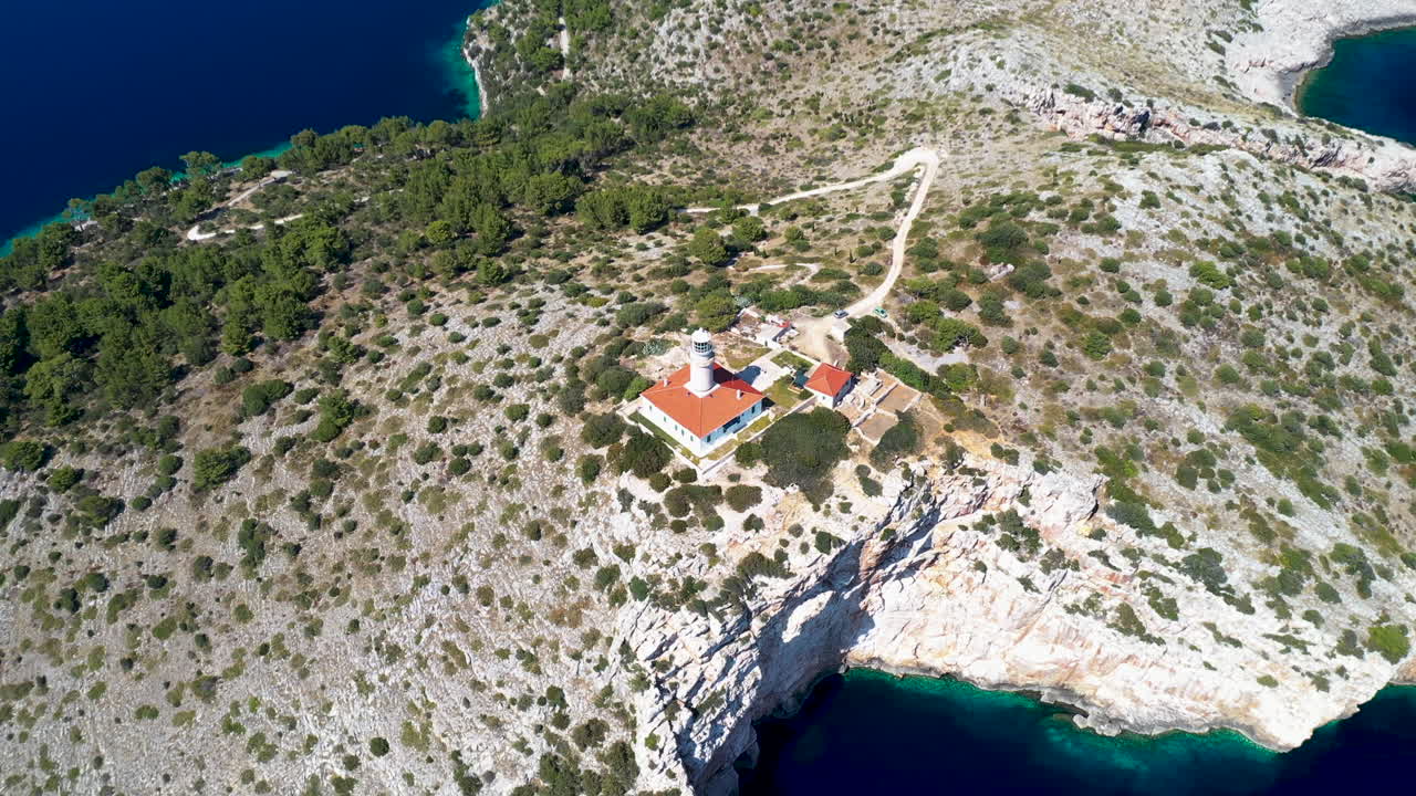 Lighthouse Cape Struga Stands On Cliff Of Lastovo Island In Croatia. - aerial