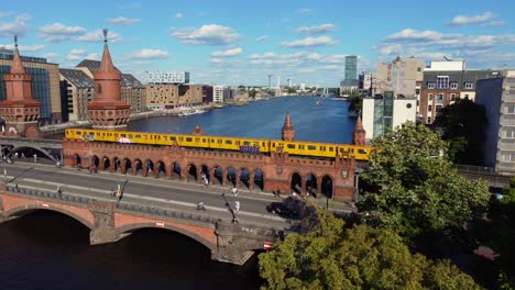 yellow subway crosses the red brick bridge