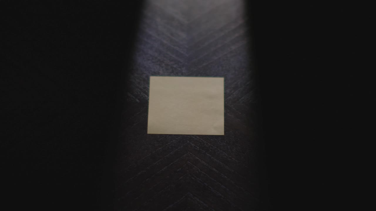 A transition piece with "Thursday" written on a piece of paper in slow motion under dramatic lighting. The paper is then picked up and placed back down