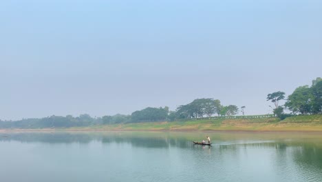 establisher handheld shot of asian traditional fishing boat in middle of river