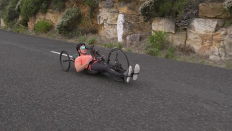 disabled man riding a recumbent bicycle