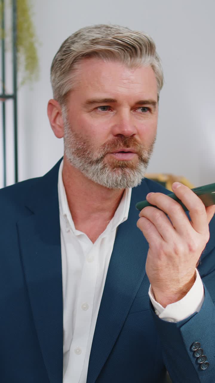 Mature business man working having mobile phone talk at office workplace using messenger chat apps