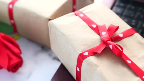 gifts wrapped in brown paper with red ribbon