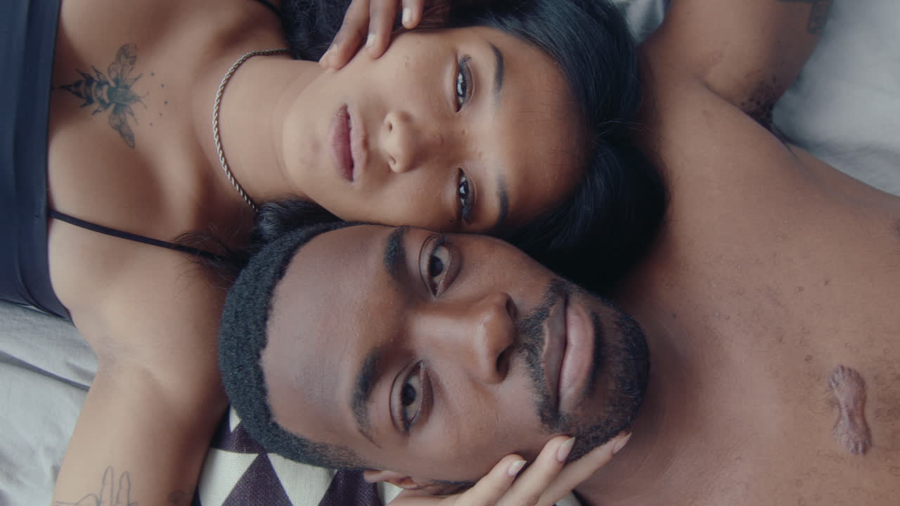 Overhead Shot of Young Loving Couple Lying Down on Bed