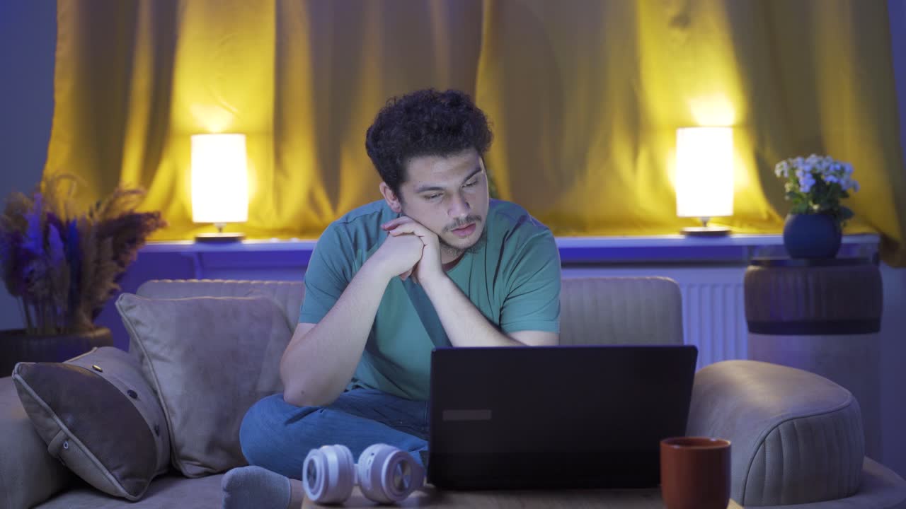 Exhausted man at home at night. Helpless facial expression.