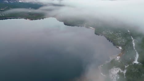 Mist-shrouding-Loch-Ness-and-the-surrounding-by-a-snow-capped-landscape