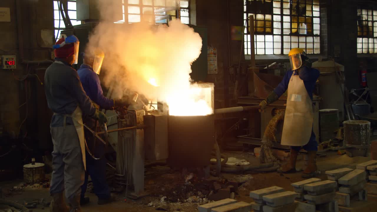 Worker melting metal in foundry workshop 4k