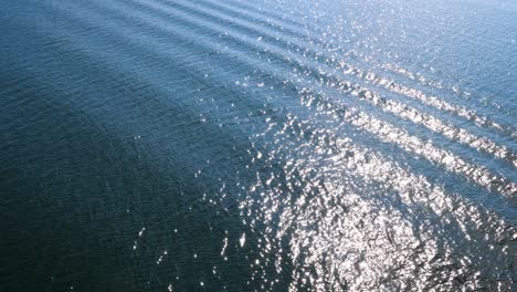 4k video of ripples and sun glare on water surface