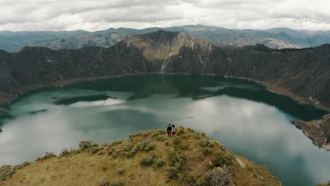 Tourists-Enjoying-Scenic-View-Of-Quilotoa-Lake-In-Ecuador---aerial-drone-shot