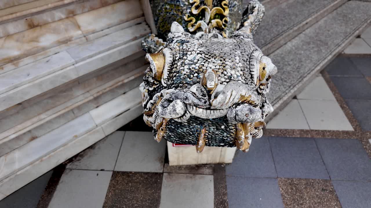 Ornate naga dragon stone sculpture guarding a Thai temple, intricate details and sacred guardian motif