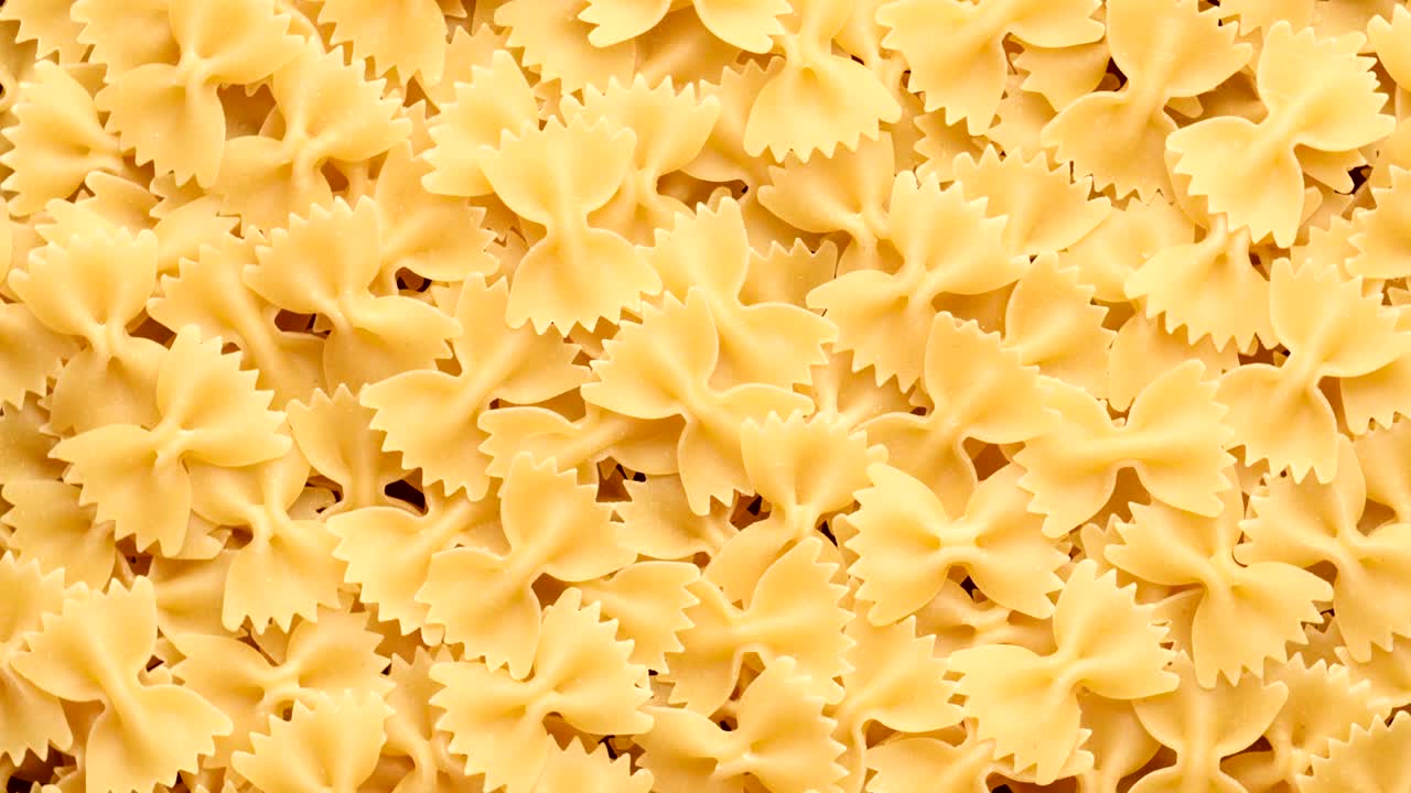 Pile of raw italian farfalle pasta in motion