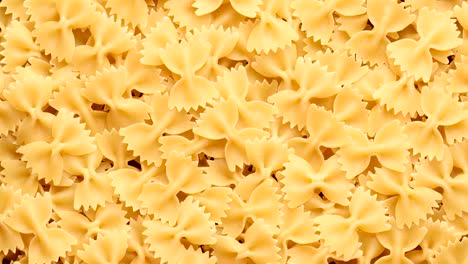 pile of raw italian farfalle pasta in motion