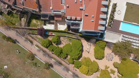 Aerial-View-Of-Green-Garden-of-Cerca-da-Graca-With-Saint-Georges-Castle-In-Background,-Lisbon