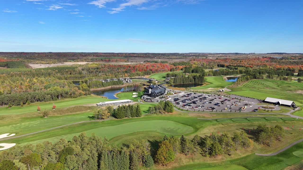 Aerial panorama of lush, mowed, and well-trimmed fairways of Golf Course on bright sunny day