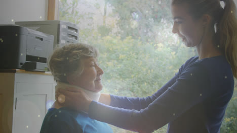 spots of light against young woman putting neck support belt on senior woman