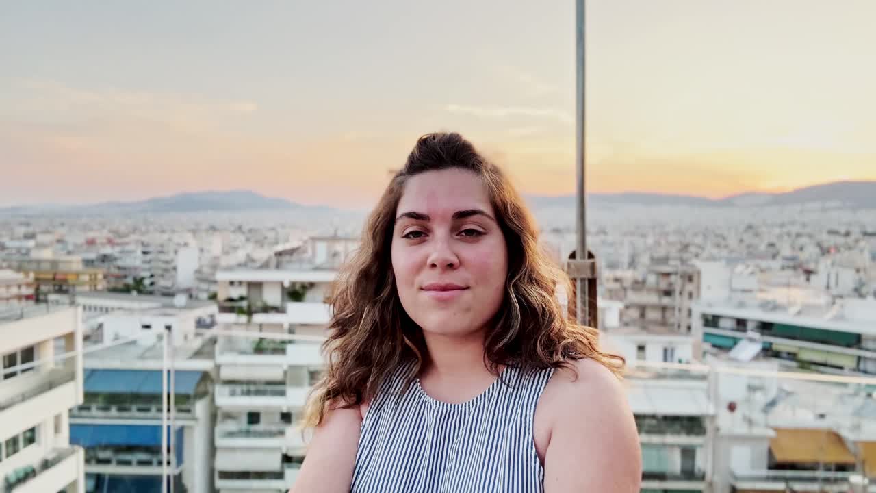 Woman Vlogger Admiring Athens Cityscape at Golden Hour