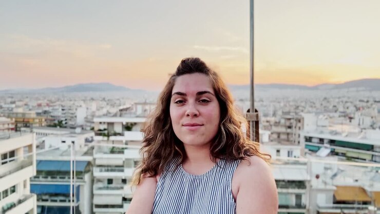Woman Vlogger Admiring Athens Cityscape at Golden Hour