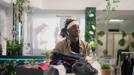 man looking at casual clothes in mall